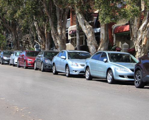 Side view of cars lining a street