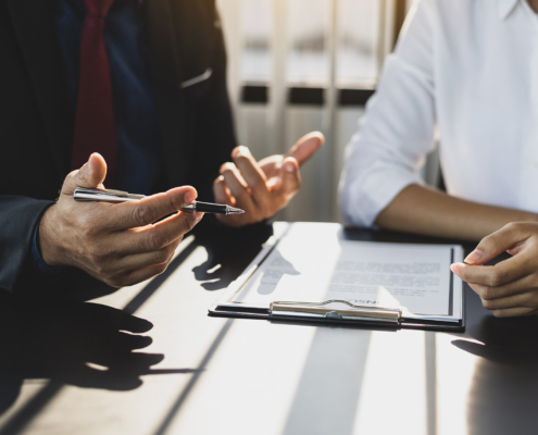 Businessman in suit in his office showing an insurance policy