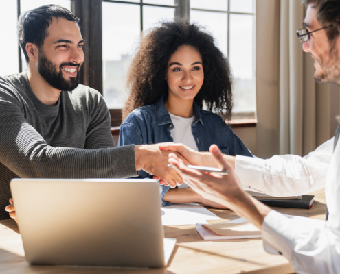 Side view of meeting people shaking hands